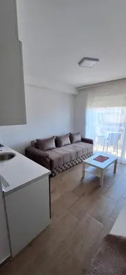 a living room with a couch and a table at Ekskluziv apartmani in Paraćin