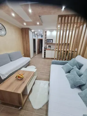 a living room with two beds and a coffee table at SWAN Kopaonik in Kopaonik
