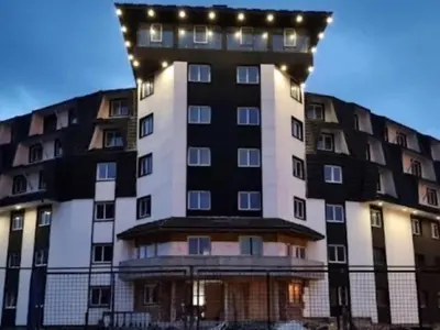 a tall building with lights on top of it at SWAN Kopaonik in Kopaonik