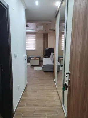 a hallway leading to a living room with a couch at SWAN Kopaonik in Kopaonik
