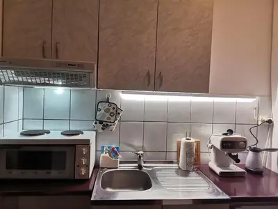 a kitchen with a sink and a microwave at Apartman kod Vrapca in Vrnjačka Banja