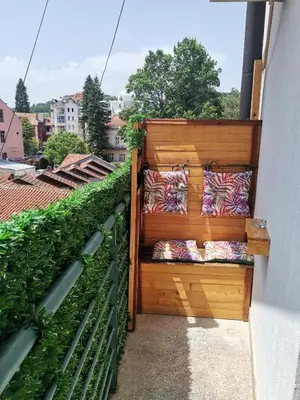 a balcony with pillows on a wooden wall at Apartman kod Vrapca in Vrnjačka Banja