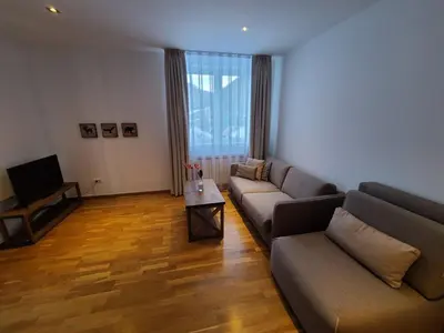 a living room with two couches and a television at Bela Brada - Brzeće, Kopaonik in Brzeće