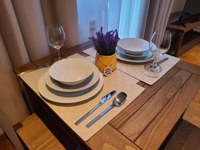 a table with plates and wine glasses on it at Bela Brada - Brzeće, Kopaonik in Brzeće