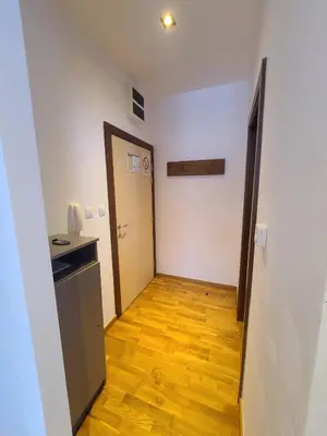 a hallway with a door and a wooden floor at Bela Brada - Brzeće, Kopaonik in Brzeće