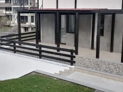 a porch of a building with a wooden fence at Bela Brada - Brzeće, Kopaonik in Brzeće