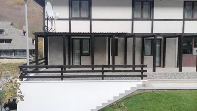 a black bench sitting on the side of a building at Bela Brada - Brzeće, Kopaonik in Brzeće
