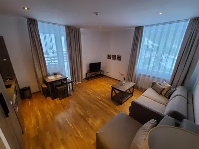 a living room with a couch and a television at Bela Brada - Brzeće, Kopaonik in Brzeće