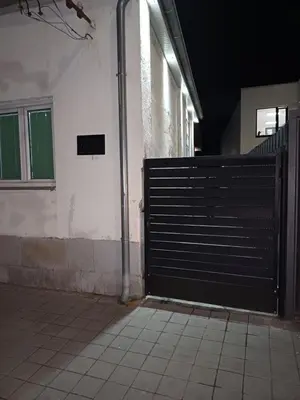 a black gate in a building with a tiled floor at Apartman “Sanja” in Pirot