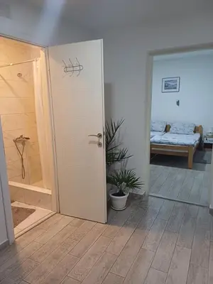 a room with a door leading to a bedroom at Apartman “Sanja” in Pirot
