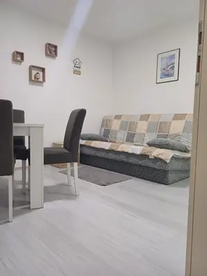 a living room with a couch and a table at Apartman “Sanja” in Pirot