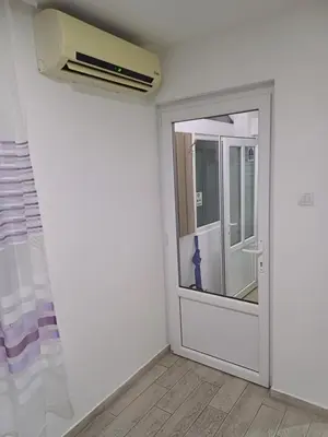 a room with a door and a air conditioner at Apartman “Sanja” in Pirot