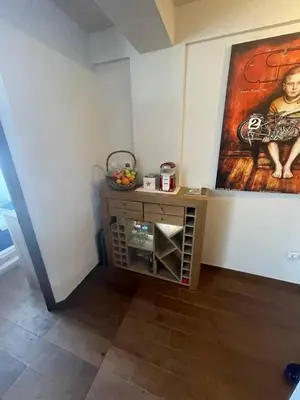 a room with a table and a painting on the wall at Vidik Kopaonik in Kopaonik