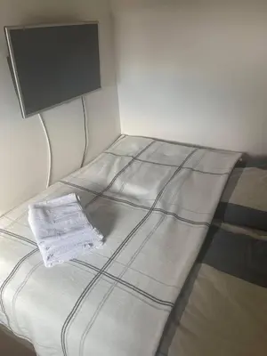 a white bed with a tv on top of it at Vidik Kopaonik in Kopaonik