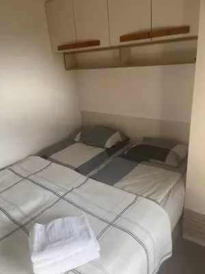 two beds in a small room with white walls at Vidik Kopaonik in Kopaonik