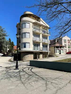 a large apartment building on a city street at Apartman Nice in Vrnjačka Banja