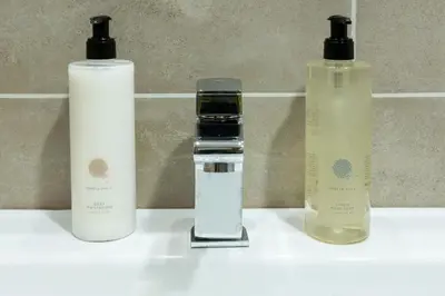 a group of three bottles sitting on a sink at Sunset View Ski & Spa apartments Kopaonik in Kopaonik