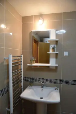 a bathroom with a sink and a mirror at Apartman Kentaur Vrnjačka Banja in Vrnjačka Banja