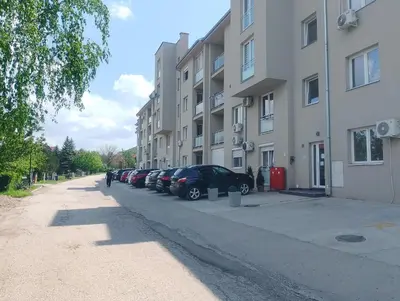 a row of cars parked next to a building at Studio La Casa in Soko Banja