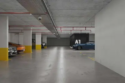 a parking garage with several cars parked in it at Hotel Djina - Kopaonik in Kopaonik