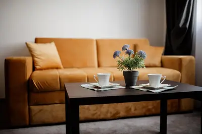 a living room with a couch and a coffee table at Hotel Djina - Kopaonik in Kopaonik