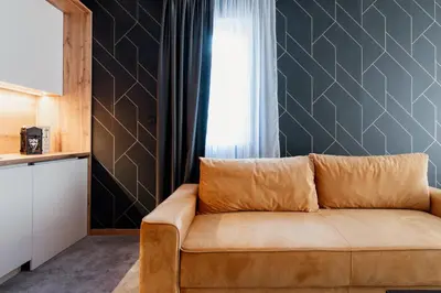 a living room with a couch and a window at Hotel Djina - Kopaonik in Kopaonik
