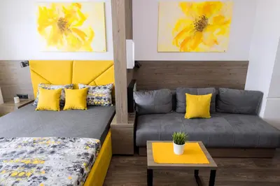 a bedroom with a bed and a couch at Apartment Sun - President Kop A512 in Kopaonik