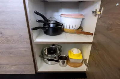 a cupboard with some pots and pans on it at Apartment Sun - President Kop A512 in Kopaonik