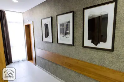 a hallway with four pictures on a wall at Apartment Sun - President Kop A512 in Kopaonik