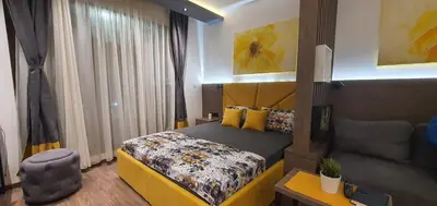 a hotel room with a bed and a chair at Apartment Sun - President Kop A512 in Kopaonik