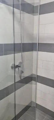 a shower with a glass door in a bathroom at Kraljevi Cardaci 9D 12- Sunny view in Kopaonik