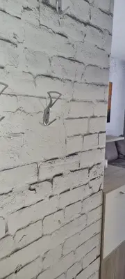 a white brick wall with two birds on it at Kraljevi Cardaci 9D 12- Sunny view in Kopaonik