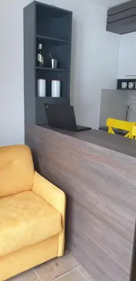 a living room with a yellow couch and a counter at Kraljevi Cardaci 9D 12- Sunny view in Kopaonik