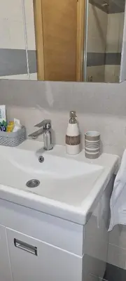 a white sink in a bathroom with a mirror at Kraljevi Cardaci 9D 12- Sunny view in Kopaonik