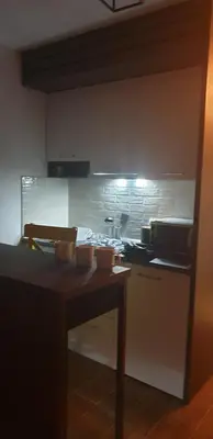 a kitchen with a counter and a stove top oven at Kraljevi Cardaci 9D 12- Sunny view in Kopaonik