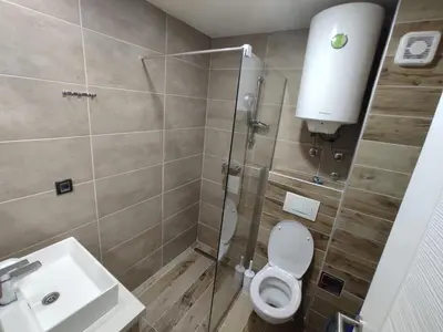 a bathroom with a shower and a toilet and a sink at Milmari N80, Kopaonik in Raška