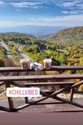 a wooden picnic table with a view of a road at Milmari N80, Kopaonik in Raška
