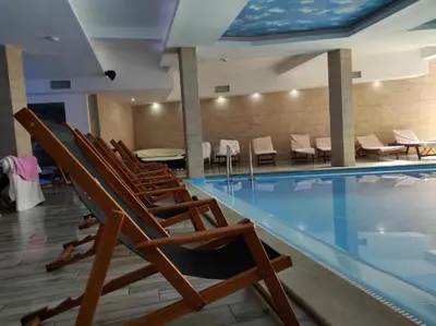 a group of chairs sitting next to a swimming pool at Milmari N80, Kopaonik in Raška