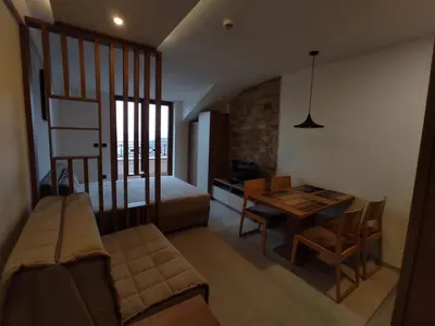 a living room with a couch and a dining room table at Milmari N80, Kopaonik in Raška