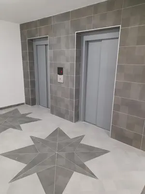 a room with two doors and a tile wall at Holiday apartments in Niš
