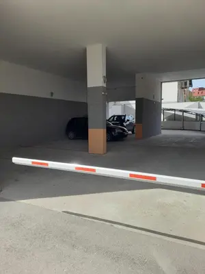 a parking garage with a parking lot with cars in it at Holiday apartments in Niš