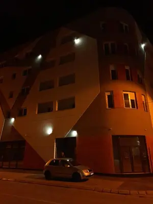 a car parked in front of a building at night at Holiday apartments in Niš