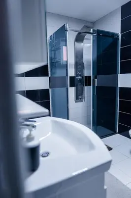 a bathroom with a shower and a white sink at Apartmani Đorđević in Soko Banja