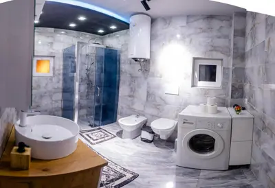a bathroom with a toilet sink and a washing machine at Apartmani Đorđević in Soko Banja