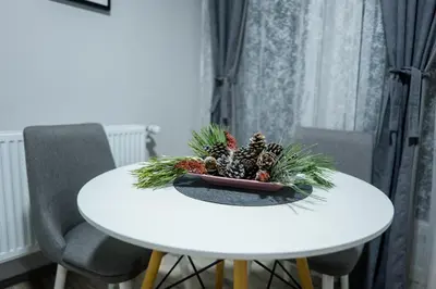 a white table with a plant on top of it at Apartmani Đorđević in Soko Banja