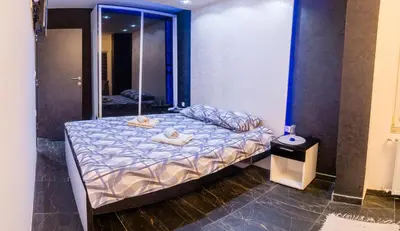 a bedroom with a bed with towels on it at Apartmani Đorđević in Soko Banja