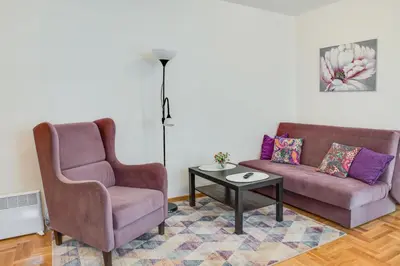 a living room with two chairs and a couch and a table at Apartment Joy by Central in Vrnjačka Banja