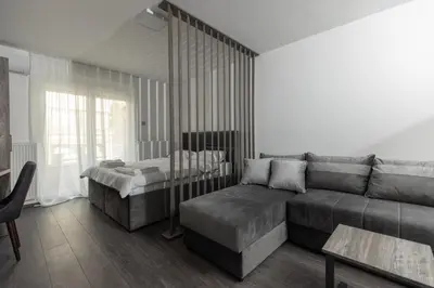 a living room with a couch and a bed at Hany Sweet in Niš