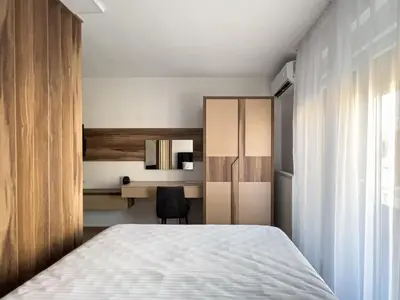 a bedroom with a bed and a desk and a chair at Hany Sweet in Niš