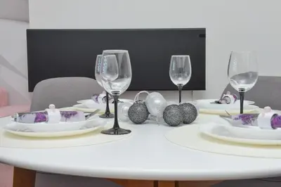 a white table with wine glasses and decorations on it at Apartmani Martenovic in Vrnjačka Banja